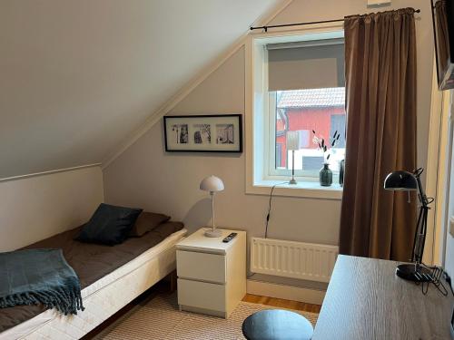 Boende med hotellkänsla- Stallhammarhagen في سالا: غرفة نوم صغيرة بها سرير ونافذة