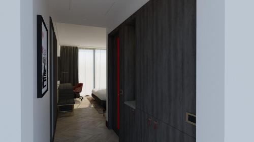a hallway with a room with a bed and a room with a door at Ramada by Wyndham Arnavutkoy in Istanbul