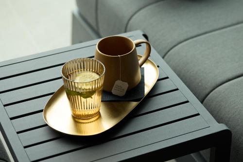 a tray with a cup and a drink on a table at Hotel Lido in Ledro