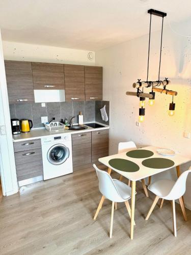 a kitchen with a table and chairs in a kitchen at Seebrise in Wendtorf