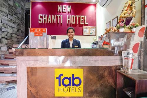 a woman standing behind the counter of a new shark hotel at FabHotel New Shanti in Allahābād
