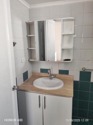 a bathroom with a sink and a mirror at Elixir Two Bed Rooms in Hurghada