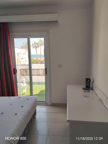 a bedroom with a bed and a view of the ocean at Elixir Two Bed Rooms in Hurghada