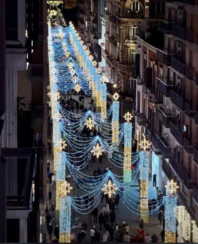 a christmas tree in a city at night at Orchidea suites - City center in Bari