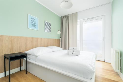 En eller flere senge i et værelse på Przy Plaży - City Apartments