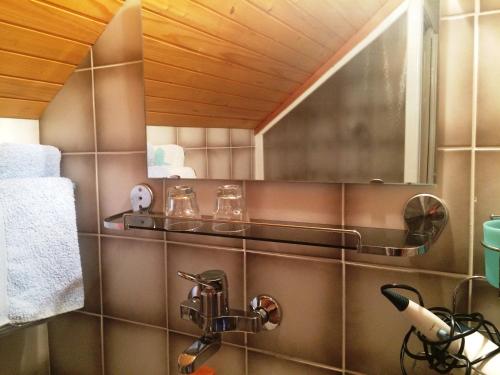 ein Bad mit einem Waschbecken und einem Wandspiegel in der Unterkunft Farm Stay Juvanija in Solčava
