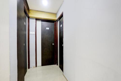 an empty corridor with two doors in a building at Hotel O Wardha Road Near Airport in Nagpur