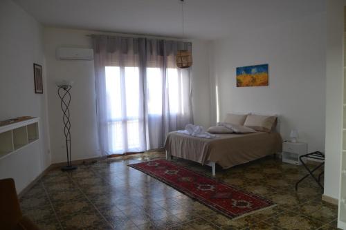 a bedroom with a bed and a large window at The Domus in Olmedo