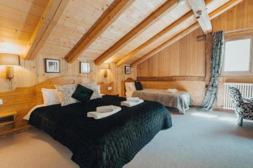 a bedroom with a large bed in a room at La Ferme a Mamy - Snowytrees in Morzine