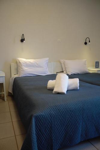 two beds with white pillows sitting next to each other at Marylee's studio Old town Rethymno standard studio Adults Only in Rethymno