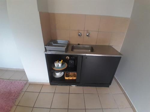 a small kitchen with a sink and a counter top at Mountain Vue in Hartbeespoort
