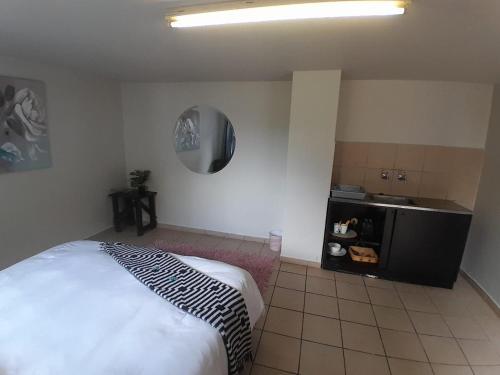 a bedroom with a bed and a mirror on the wall at Mountain Vue in Hartbeespoort