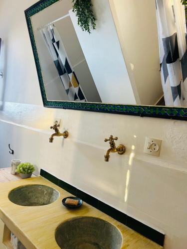 a bathroom with a sink and a mirror at Surf Sun Sea Lodge in Wassane
