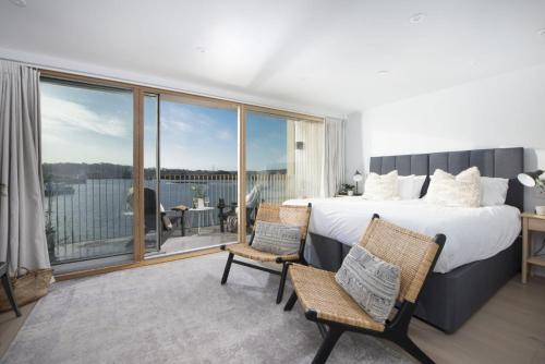 a bedroom with a large bed and a balcony at 10 Cannery Row - Stunning Views - Pet Welcome - Free WiFi & Parking in Hayle