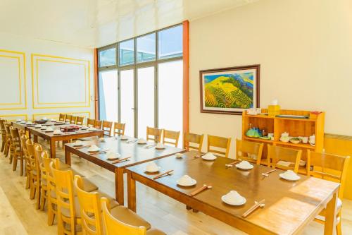 a large room with a long table and chairs at 999 Hotel Lào Cai in Yên Bái