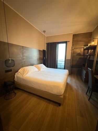 a bedroom with a bed and a window in it at Hotel Concorde in Arona