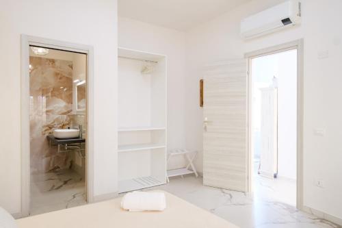 a white bathroom with a shower and a sink at Costa Private room in Castelsardo