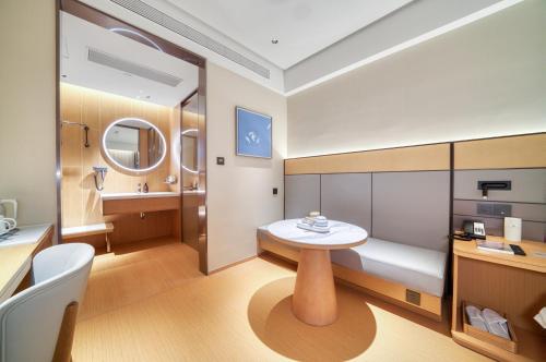 a small bathroom with a table and a sink at JI Hotel Hangzhou West Railway Station in Hangzhou