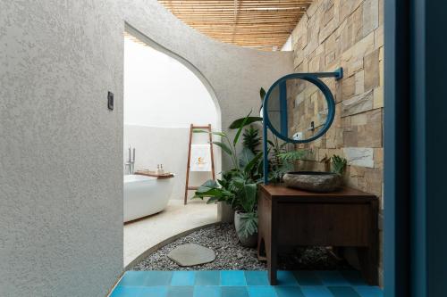 a bathroom with a mirror and a tub and a sink at MOONLIGHT Homestay & Hotel in Pleiku