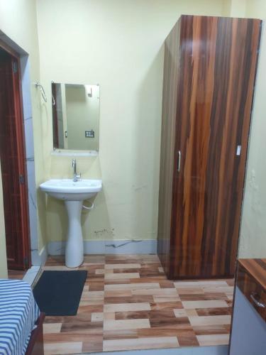 a bathroom with a sink and a mirror and a shower at Hotel Star, Agartala in Agartala