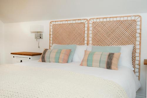 a bedroom with a white bed with two pillows at Carnglas, Gweedore, County Donegal in Donegal
