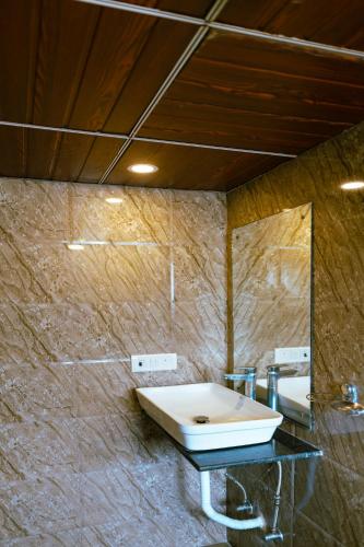a bathroom with a sink and a mirror at CozyKey Rooms Bandra in Mumbai