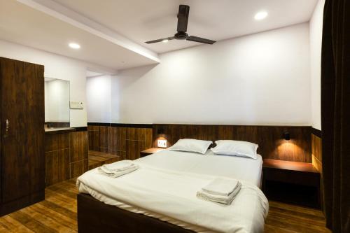 a bedroom with a bed with two towels on it at CozyKey Rooms Bandra in Mumbai
