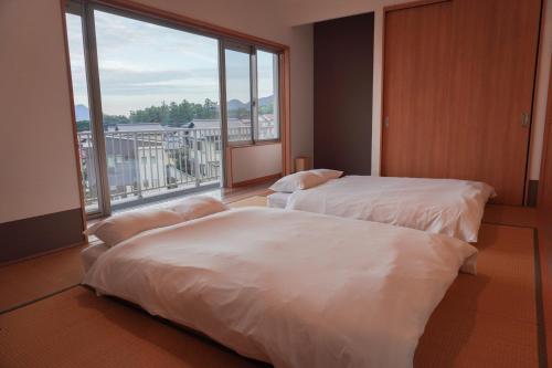 Postel nebo postele na pokoji v ubytování Beppu Ohana