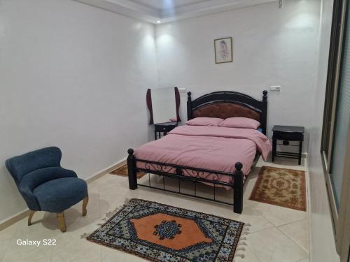 een slaapkamer met een bed en een stoel bij bedroom double bed private bathroom in Agadir