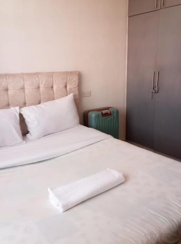a large white bed with a white pillow on it at Victorian Haven in Eldoret