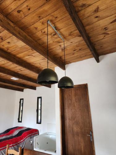 a room with two lights hanging from a ceiling at AIRES DEL BOSQUE Con JACUZZI in Punta Del Diablo