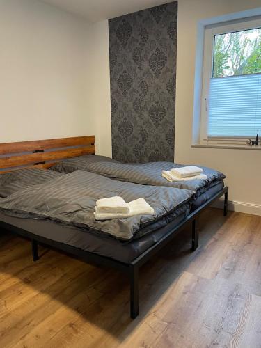 a bed in a room with two towels on it at Apartment in Seevetal in Seevetal