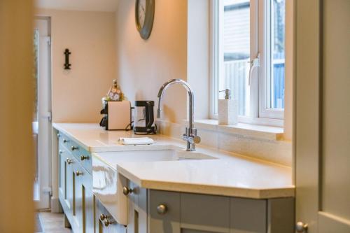 a kitchen with a sink and a window at Middle Cottage by Keepers Cottages in Sandwich