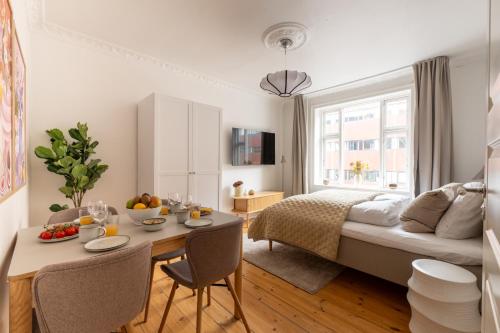 a bedroom with a bed and a table with fruit on it at Lovely City Apartments in Vibrant Area of Copenhagen in Copenhagen