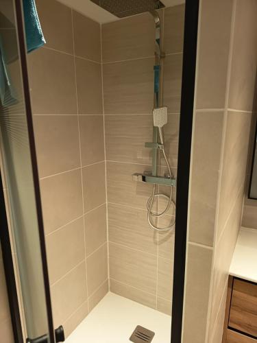 a shower with a glass door in a bathroom at Maison de vacances en Ardèche in Pailharès