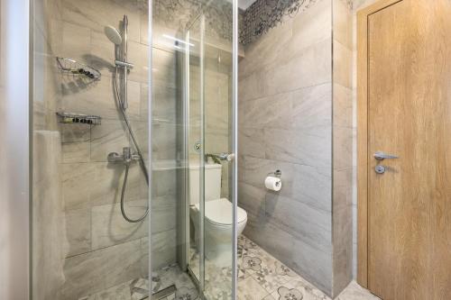 a bathroom with a glass shower with a toilet at 74 Prokymea- Steps from the Sea, Downtown, Balcony in Limassol