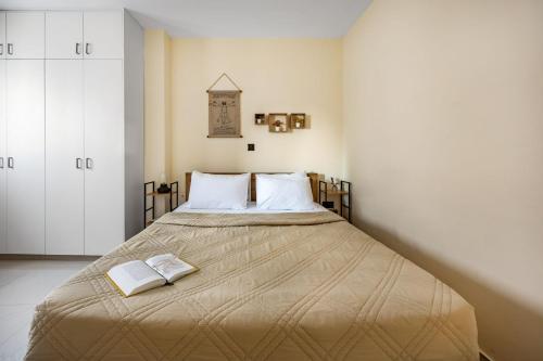 a bedroom with a large bed with two books on it at 74 Prokymea- Steps from the Sea, Downtown, Balcony in Limassol
