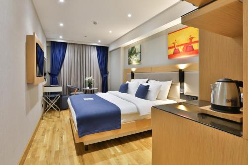 a hotel room with a bed and a desk at Istanbul Taksim Pera Star Hotel - Istiklal Street in Istanbul