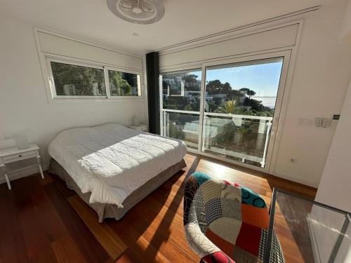 ein Schlafzimmer mit einem Bett und einem großen Fenster in der Unterkunft Villa Martin AV-88 in Montjoys