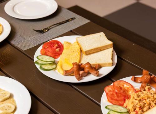 a table with plates of food on a table at Seoul Hotel Cat Ba in Cat Ba