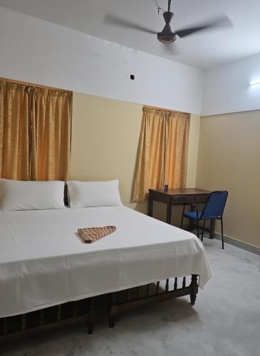a bedroom with a large bed and a table at LUXUS INN JA Star in Chacka