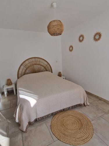 a bedroom with a bed in a white room at Au bout du chemin Chez Tina in Sarrians