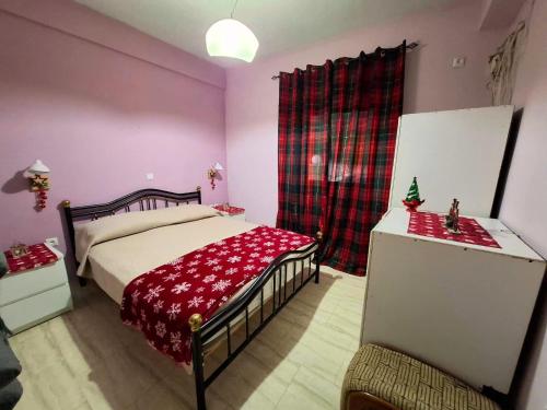 a bedroom with a bed with a red blanket at Eretria Panorama Seaview Retreat with Balcony in Eretria