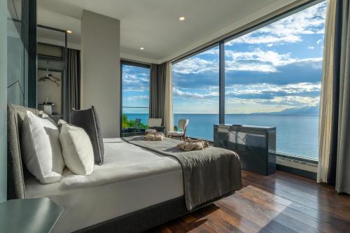 a bedroom with a bed with a view of the ocean at Lucky Monkey Hotel in Antalya