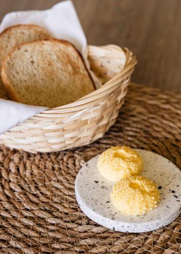 two slices of bread and a basket of bread at Diaz Ocean View Hotel & Spa in Mossel Bay