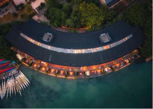an aerial view of a marina with lights in the water at XIN HOTEL in Hangzhou