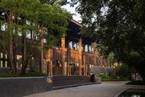 a building with a staircase in front of it at XIN HOTEL in Hangzhou