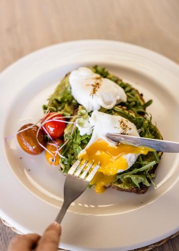 a plate of food with an egg on top at Diaz Ocean View Hotel & Spa in Mossel Bay