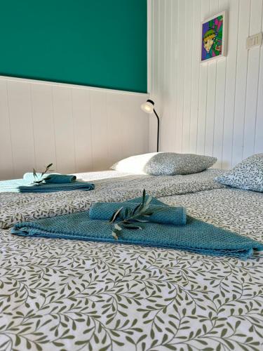 two beds with blue towels on them on the floor at Studio Apartma Olive, Nova Gorica, Slovenia in Nova Gorica