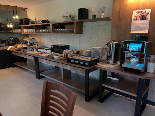a kitchen with a long table with food on it at Willa Pachówka - tam, gdzie natura spotyka się z nowoczesnością in Bukowina Tatrzańska